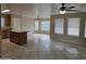 Spacious living room with multiple windows and ceiling fans, open to the kitchen area at 4405 W Park St, Laveen, AZ 85339