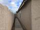 Narrow walkway along the side of the house featuring a stucco wall at 4405 W Park St, Laveen, AZ 85339