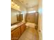 Bright bathroom with a granite vanity, framed mirror, and shower-over-tub design at 50 S Elmont Dr, Apache Junction, AZ 85120