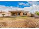 Rear exterior showing a spacious backyard with a covered patio and landscaping at 5108 N 191St Dr, Litchfield Park, AZ 85340