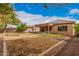 Rear view of home displaying back patio and large, low maintenance backyard at 5108 N 191St Dr, Litchfield Park, AZ 85340