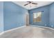 Bedroom with tile floors, blue walls, and a window with blinds at 5108 N 191St Dr, Litchfield Park, AZ 85340