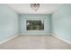 Bright bedroom featuring tile floors, neutral paint, and a modern chandelier at 5108 N 191St Dr, Litchfield Park, AZ 85340