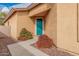 Charming home featuring a teal front door and desert landscaping at 5108 N 191St Dr, Litchfield Park, AZ 85340