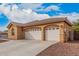 Attached three-car garage with white doors, arched detailing, and extended driveway at 5108 N 191St Dr, Litchfield Park, AZ 85340