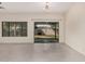 Living room with tile flooring, view to backyard through glass slider, and window at 5108 N 191St Dr, Litchfield Park, AZ 85340