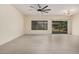 Bright living room with a contemporary ceiling fan, tile floors, and sliding glass doors to backyard at 5108 N 191St Dr, Litchfield Park, AZ 85340