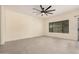 Open-concept living space with neutral paint, tile floors, a modern fan, and a large window at 5108 N 191St Dr, Litchfield Park, AZ 85340