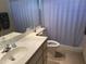 Bathroom featuring a spacious vanity and a bathtub with a shower behind a white curtain at 518 W Beverly Ln, Phoenix, AZ 85023