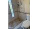 Bathroom with a walk-in shower featuring decorative tilework and a convenient built-in shower niche at 518 W Beverly Ln, Phoenix, AZ 85023