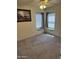 Bright bedroom featuring two windows with blinds, neutral carpeting, and a ceiling fan with a light fixture at 518 W Beverly Ln, Phoenix, AZ 85023