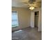 This bedroom has neutral carpeting, window with blinds, closet, and ceiling fan at 518 W Beverly Ln, Phoenix, AZ 85023