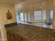 Open kitchen featuring granite countertops and an eat-in bar area at 518 W Beverly Ln, Phoenix, AZ 85023