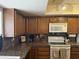 A close-up of the kitchen featuring wooden cabinets and granite countertops at 518 W Beverly Ln, Phoenix, AZ 85023