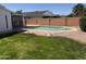 Backyard pool with lush green grass, a brick-lined edge, and a block fence for privacy at 518 W Beverly Ln, Phoenix, AZ 85023