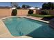 Sparkling pool surrounded by lush landscaping and a brick-lined edge, enclosed by a private block fence at 518 W Beverly Ln, Phoenix, AZ 85023