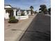 Well-maintained homes line a sunny street, showcasing the community's appealing curb appeal at 518 W Beverly Ln, Phoenix, AZ 85023