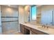 Bathroom with double sink vanity, quartz countertops, glass shower, and tile flooring at 5440 W Snowbird Dr, Eloy, AZ 85131