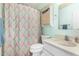 The bathroom has an updated sink and vanity, toilet and shower with patterned shower curtain at 6018 N 30Th Ave, Phoenix, AZ 85017