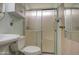 Cozy bathroom features a toilet and shower with sliding glass doors, along with a sink and vanity area at 7750 E Broadway Rd # 225, Mesa, AZ 85208