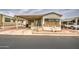 Charming mobile home featuring a covered carport and landscaped yard with inviting curb appeal at 7750 E Broadway Rd # 225, Mesa, AZ 85208