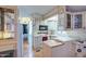 Cozy kitchen with white cabinetry, wood-style floors, and lots of natural light and plenty of counter space at 7750 E Broadway Rd # 225, Mesa, AZ 85208
