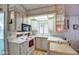 Bright kitchen with white appliances, counter space, and a window above the sink providing lots of natural light at 7750 E Broadway Rd # 225, Mesa, AZ 85208