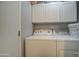 Laundry Room with a white washer and dryer set and white storage cabinets at 7750 E Broadway Rd # 225, Mesa, AZ 85208