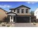 Charming two-story home featuring modern farmhouse design, two car garage, and inviting front porch at 7976 W Griswold Rd, Peoria, AZ 85345