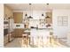 Bright kitchen with white countertops, island with seating, wood cabinets and modern stainless steel appliances at 7976 W Griswold Rd, Peoria, AZ 85345