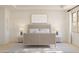 Bright main bedroom featuring a neutral color palette, stylish furnishings, and decorative wall art at 7976 W Griswold Rd, Peoria, AZ 85345