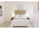 Serene bedroom with a tufted headboard, neutral tones, and elegant decor at 7976 W Griswold Rd, Peoria, AZ 85345