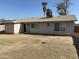 Expansive backyard featuring a sliding glass door, stucco exterior, and sparse, drought-resistant landscaping at 808 N 67Th Ln, Phoenix, AZ 85043