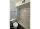 Bathroom with a shower with shelves and a low-flow toilet at 808 N 67Th Ln, Phoenix, AZ 85043