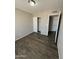 Bedroom with a closet with sliding doors and wood-look flooring at 808 N 67Th Ln, Phoenix, AZ 85043
