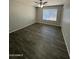Cozy bedroom featuring a ceiling fan, a bright window, and stylish wood flooring at 808 N 67Th Ln, Phoenix, AZ 85043