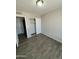 Bedroom with a closet with sliding doors and wood-look flooring at 808 N 67Th Ln, Phoenix, AZ 85043