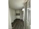 Hallway with wood-style flooring, neutral paint, and two storage closets at 808 N 67Th Ln, Phoenix, AZ 85043