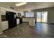 Bright kitchen featuring a black appliance suite, white cabinets, and a convenient kitchen island at 808 N 67Th Ln, Phoenix, AZ 85043