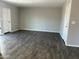 Spacious living room with modern wood flooring and ample natural light at 808 N 67Th Ln, Phoenix, AZ 85043