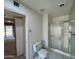 Bathroom featuring a white toilet, tile floor, and frosted glass-enclosed stand up shower at 9059 N Arroya Grande Dr, Phoenix, AZ 85028