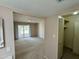 A secondary bedroom featuring neutral carpeting, and sliding glass door access to the backyard at 9059 N Arroya Grande Dr, Phoenix, AZ 85028