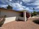 The home's front exterior with blooming bougainvillea accenting the stucco walls and pergola feature at 9059 N Arroya Grande Dr, Phoenix, AZ 85028
