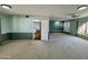 Open living room featuring neutral carpet, ceiling fan, view to the kitchen and front entry at 9059 N Arroya Grande Dr, Phoenix, AZ 85028