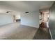 A bright, carpeted living room with neutral walls and a ceiling fan, ready for personalization at 9059 N Arroya Grande Dr, Phoenix, AZ 85028