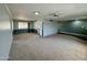 Spacious carpeted living room with large window, ceiling fan, and two-tone neutral paint at 9059 N Arroya Grande Dr, Phoenix, AZ 85028