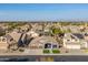 Expansive view of the neighborhood showcasing single-Gathering homes, palm trees, and mountain views at 9654 E Pantera Ave, Mesa, AZ 85212