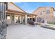 Backyard patio with outdoor seating, fire pit, built-in grill, and landscaped surroundings at 9654 E Pantera Ave, Mesa, AZ 85212