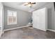 Bedroom with light gray walls, tiled floors, murphy bed, and a bright window at 9654 E Pantera Ave, Mesa, AZ 85212