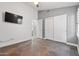 Bedroom with light gray walls, tiled floors, and ample storage space at 9654 E Pantera Ave, Mesa, AZ 85212